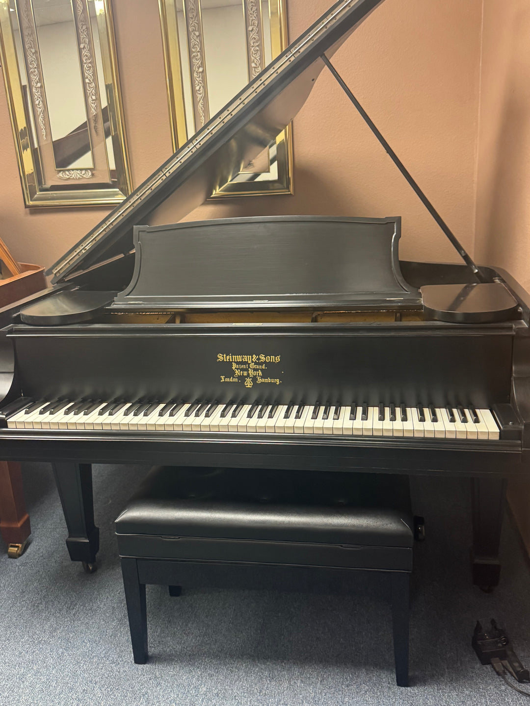 Restored Steinway Model M baby grand piano displayed in the Washington Pianos showroom